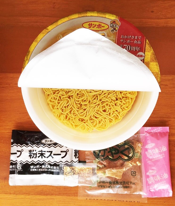 フタを開けると、中には麺の他に、かやく、粉末スープ、調味油、そしてなんと金粉（記者撮影）