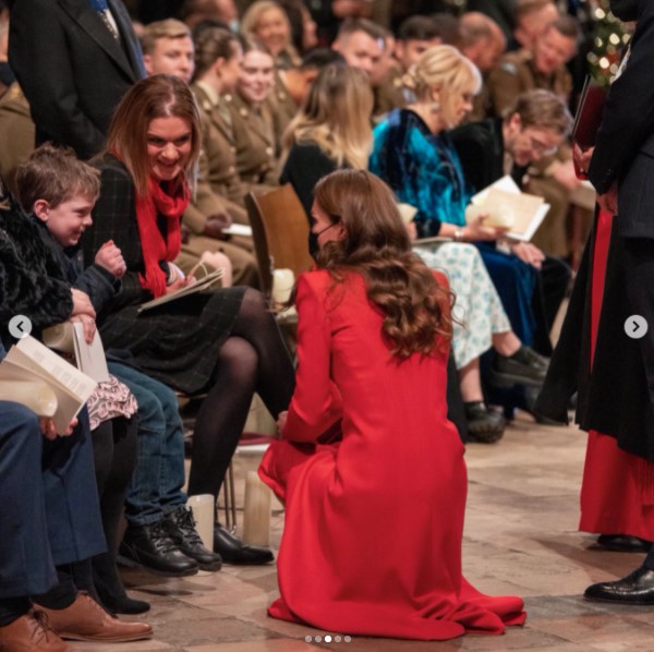 男児の目線にかがみ込み、会話するキャサリン妃（画像は『Duke and Duchess of Cambridge　2021年12月8日付Instagram「What a special evening, seeing so many familiar faces, as well as meeting inspirational people who have gone the extra mile for their community in recent times.」』のスクリーンショット）