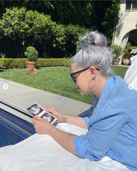 プールサイドでエコー写真を見つめるケリー（画像は『Kelly Osbourne　2022年5月12日付Instagram「I know that I have been very quiet these past few months so I thought I would share with you all as to why」』のスクリーンショット）